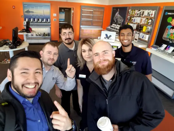 Omar Cobian with his wireless retail store team